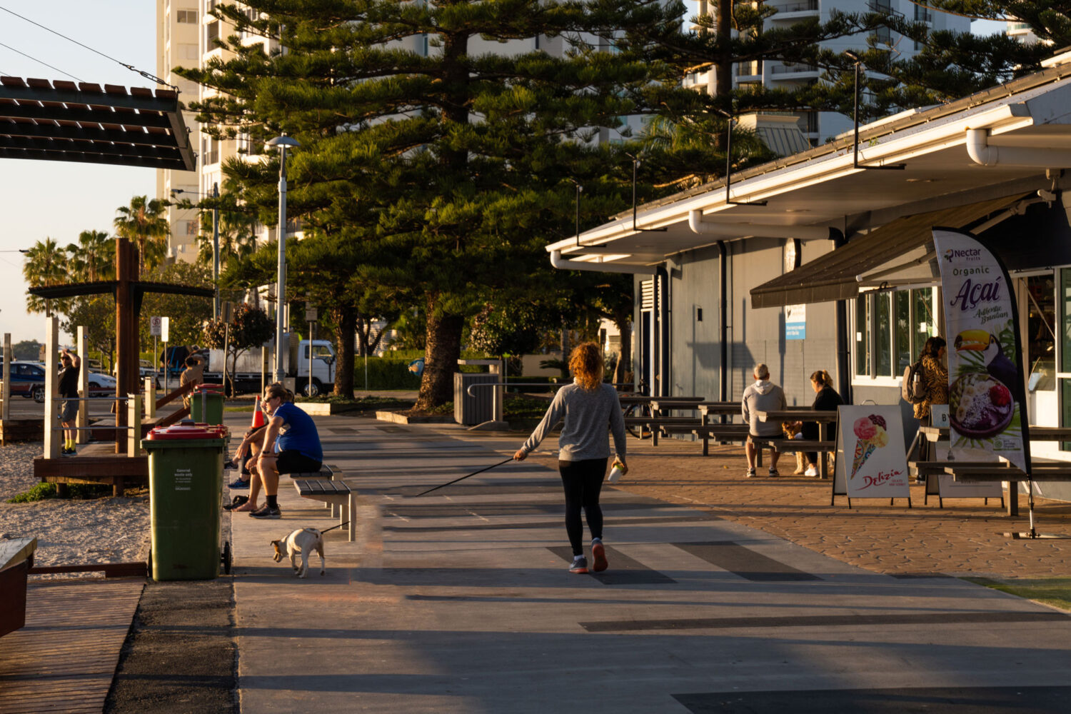 A person walking a dog outside the PARK SHORE lifestyle living property development on the Gold Coast
